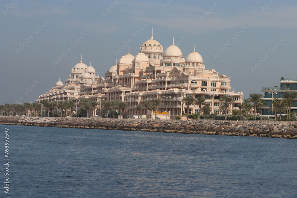 raffles the palm hotel in dubai near the sea with blue sky