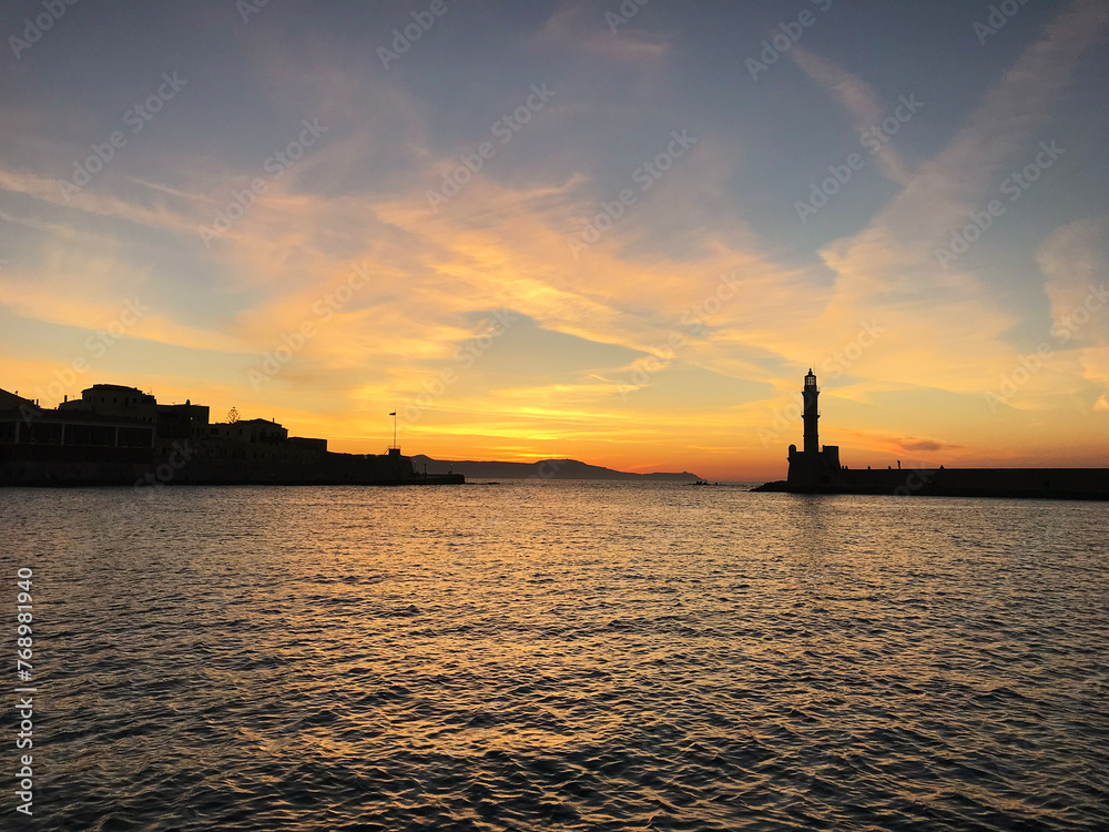 Lighthouse in the Old Venetian Harbour in Chania during sunset. Crete. Greece.