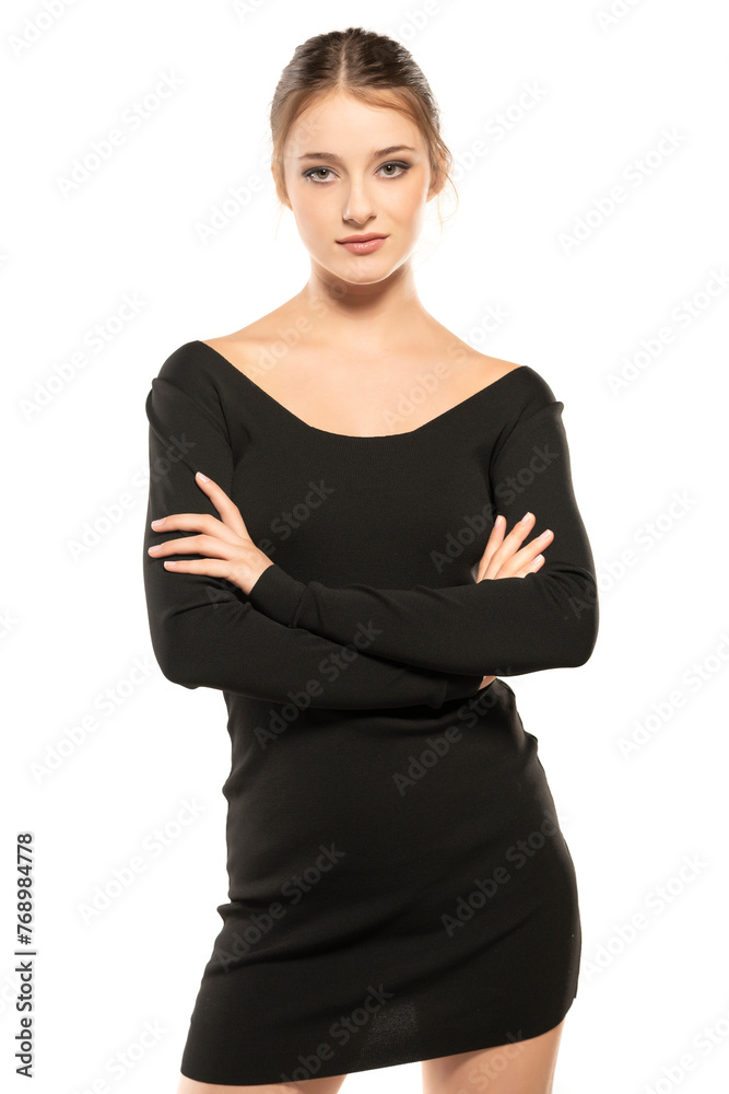 Summer Chic: Folded Arms Portrait of a Young Woman Posing in a Short Dress on White Background Summer Chic: Folded Arms Portrait of a Young Woman Posing in a Short Dress on White Background