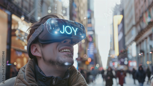 A young man walking on the street wearing VR glasses displaying the word "JOY" on the outer display. © Erich
