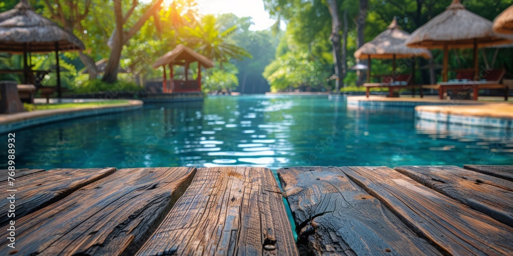 Tranquil resort pool surrounded by natural greenery under a sunny sky - obrazy, fototapety, plakaty 
