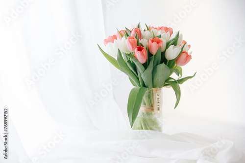 Red tulips in a white interior