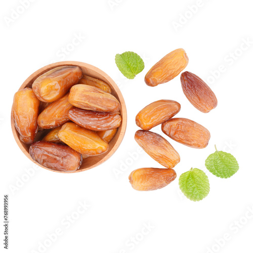 Brown dried dates in a wooden bowl with some mint leaves isolated transparent