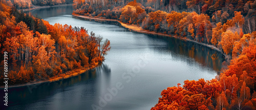 A tranquil river winding through a forest, with the colors of the autumn leaves forming a splendid gradient along the banks, captured in high-definition to highlight its mesmerizing vibrancy.