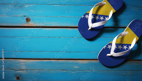 Pair of beach sandals with flag Bosnia and Herzegovina. Slippers for summer sea vacation. Concept travel and vacation in Bosnia and Herzegovina.