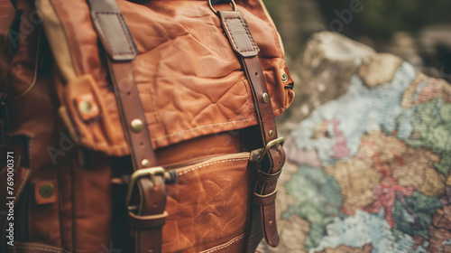 a brown backpack with a strap and a map in the background