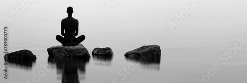 a group of rocks sitting in the middle of a lake under a cloudy sky