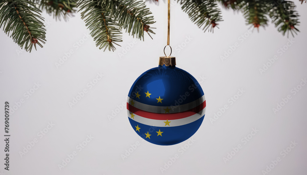 New Year's ball with the flag of Cape Verde on a Christmas tree branch isolated on white background. Christmas and New Year concept. New Year's ball with the flag of Cape Verde on a Christmas tree branch isolated on white background. Christmas and New Year concept.