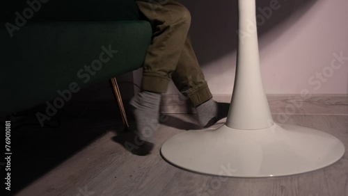 child is sitting and shaking his legs