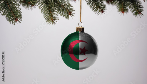 New Year's ball with the flag of Algeria on a Christmas tree branch isolated on white background. Christmas and New Year concept.