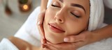 Young woman enjoying facial massage at spa salon for rejuvenating beauty treatment