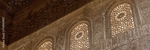 Richly detailed Arabic style wall decorations in the Royal Nazaries Palace in Alhambra, Granada, Andalusia, Spain photo