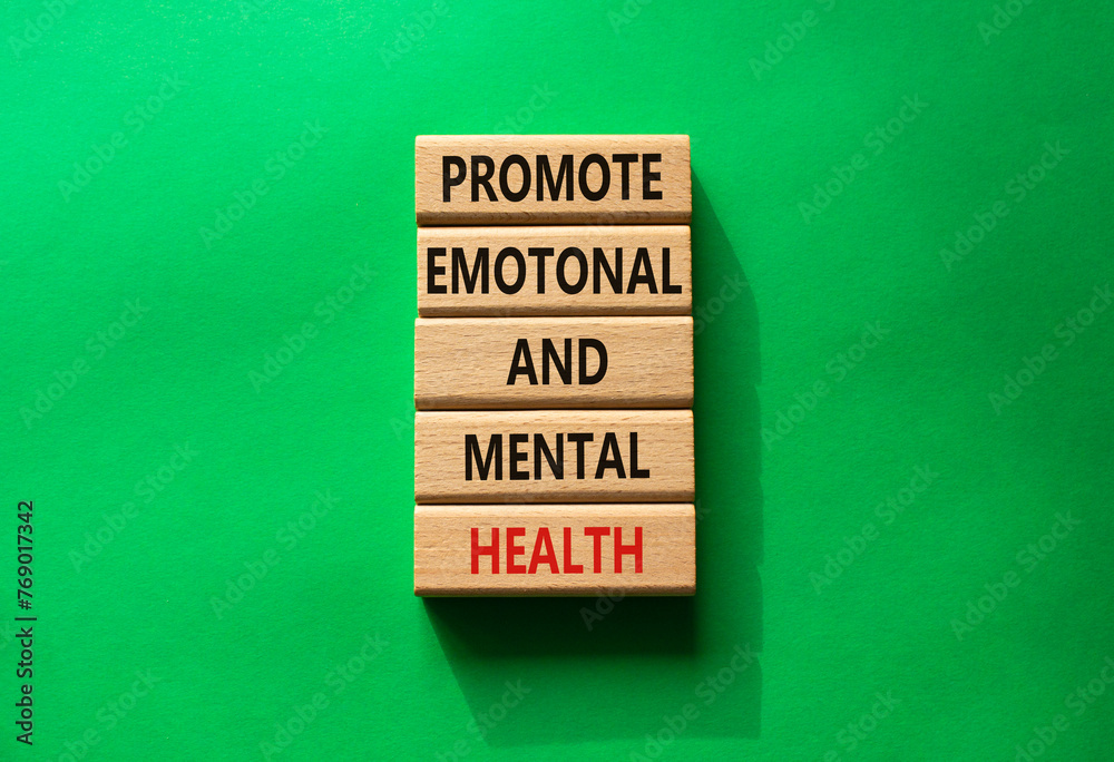 Obraz premium Health symbol. Wooden blocks with words Promote Emotional and Mental Health. Beautiful green background with. Health concept. Copy space.