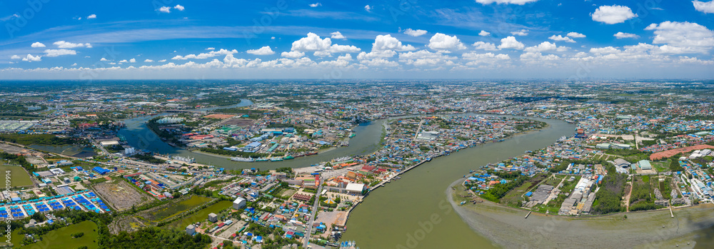 Aerial panorama view of Houses and communities along the Chao Phraya River in Samut Sakhon province of Thailand.