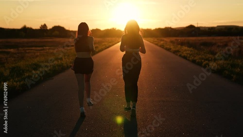 two friends running sunset, team group girls running sunset, silhouette athletic girls, teamwork gorgeous slim caucasian young, professional athletes, sports runner, wellness, cardio workout workout photo