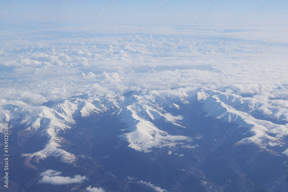 Fagaras mountains (charpathian mountains) covered with snow. Photo taken through the airplane window.