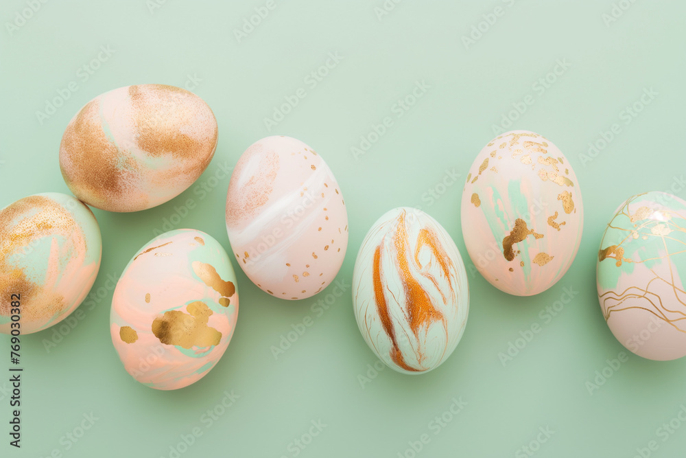 Handmade decorated pink and green Easter eggs on green background