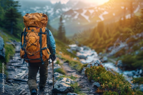 An intrepid solo hiker with a heavy backpack strides confidently through the mountainous terrain, embodying adventure and determination photo
