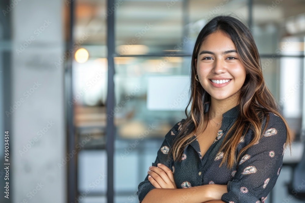 Portrait of smiling young multiethnic woman looking at camera with crossed arms Portrait of smiling young multiethnic woman looking at camera with crossed arms
