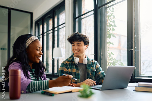 Happy university students learning together in the classroom. photo