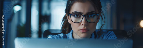 Beautiful young woman wearing glasses looking at laptop at night. Screen light reflecting in young female's glasses. Working late at evening. Generative AI