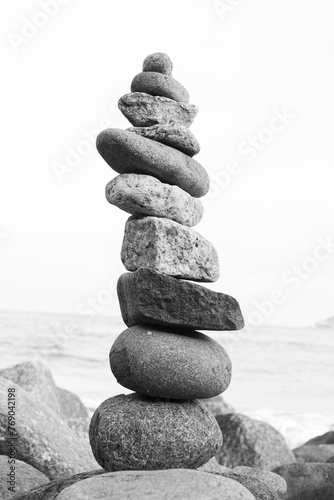 Photography black and white photograph of pile of rocks on the beach