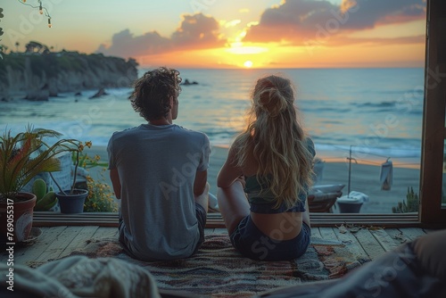 An intimate moment captured as a couple sits side-by-side on a cozy balcony overlooking a dramatic beach sunset photo