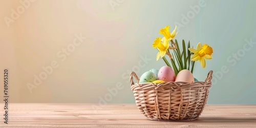 A wicker basket with colorful Easter eggs and daffodils on a table with a place for text