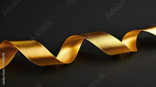 gold ribbon on a black background, symbolizing luxury and sophistication in isolation.