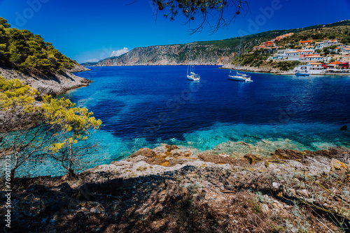 Amazing Greece, white sail boats in blue bay of picturesque colorful village Assos in Kefalonia