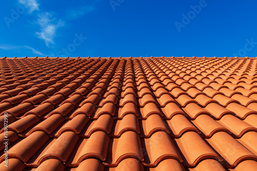 Clay tiles. Close-up of a clay tile roof against a blue sky