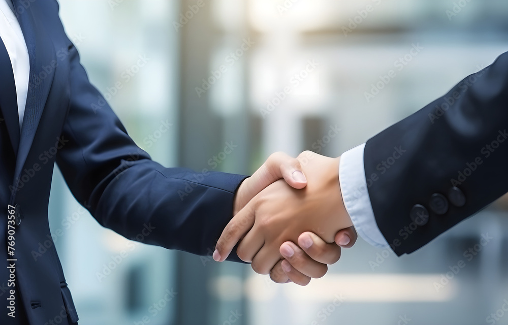 Close-up of handshake of businesswoman and businessman