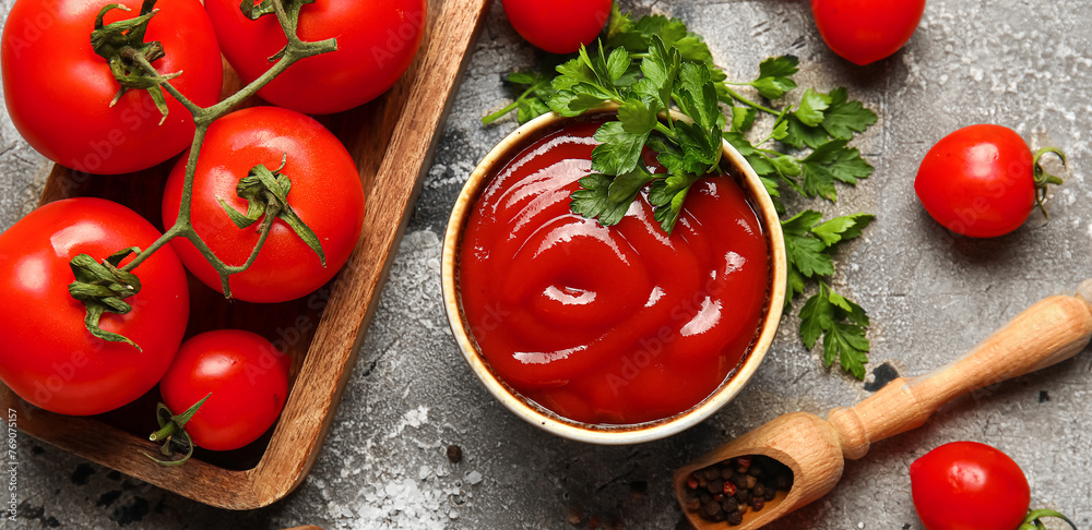 Bowl with tasty ketchup and fresh vegetables on grunge background Bowl with tasty ketchup and fresh vegetables on grunge background