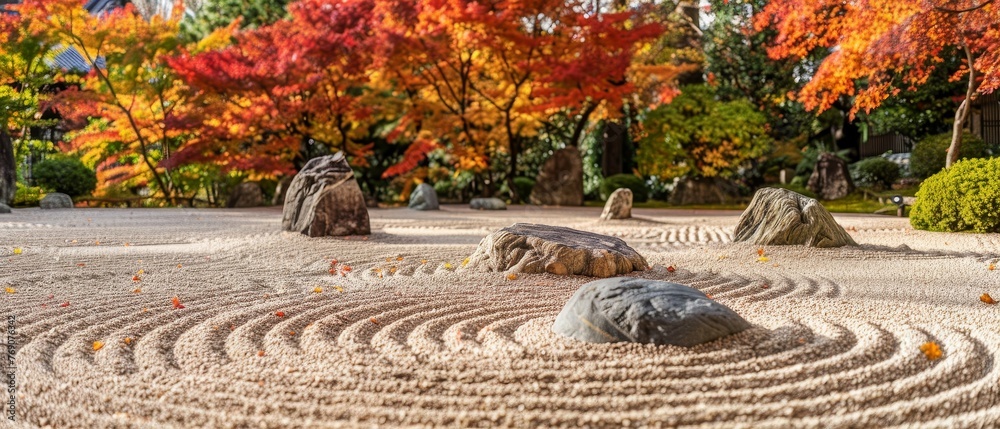 A Zen garden's tranquil setting is accentuated by the warm fall colors, inviting a moment of peace amid the raked sand and stone arrangements..