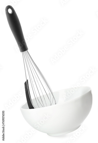 Metal whisk and ceramic bowl in air on white background. Cooking utensils