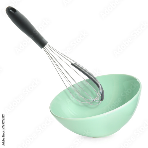 Metal whisk and light green bowl in air on white background. Cooking utensils