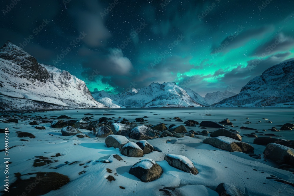 Aurora borealis illuminating snowy landscape with mountains in background
