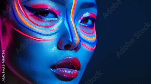 Portrait of a young woman with bright neon makeup. She is looking at the camera with her lips slightly parted.