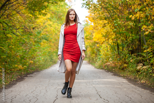 Fashion portrait of a young beautiful woman in red dress