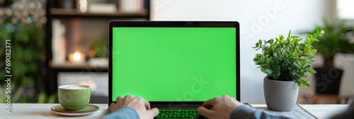 a person is typing on a laptop computer with a green screen. Generative AI