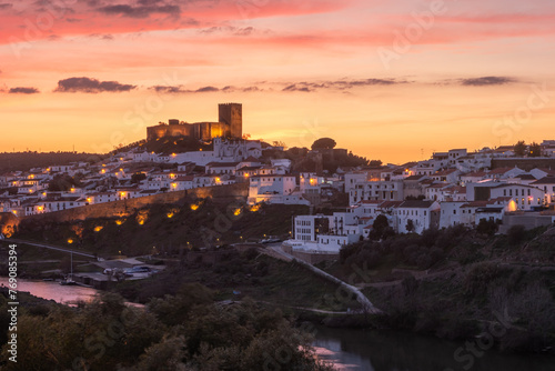 Sunset landscape in Mertola. Medieval city called Mertola in Alentejo, Portugal. Medieval castal on top of the hill in center of city photo