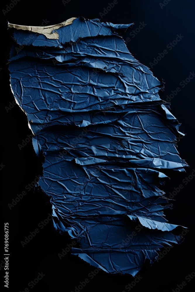 torn indigo papper on a black background with copy space for photo or blank text pattern