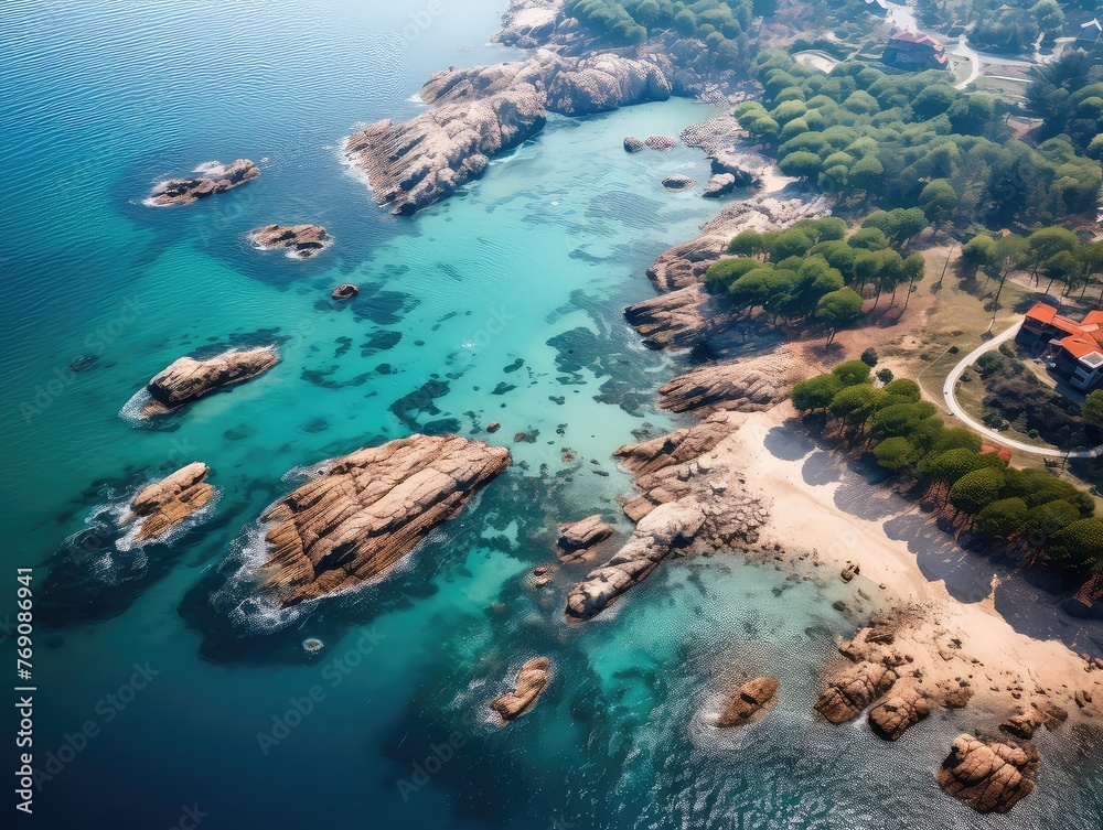 High above Qingdao's coast, sea sparkles like diamonds. Islands and reefs dot the blue canvas. Waves kiss sandy shores, creating a beautiful mosaic. Nature's masterpiece unfolds from the sky 