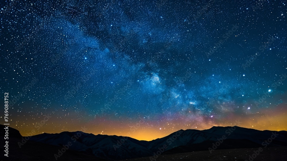 A mesmerizing Milky Way arcs across the night sky, illuminating a silent mountain valley with its celestial splendor..
