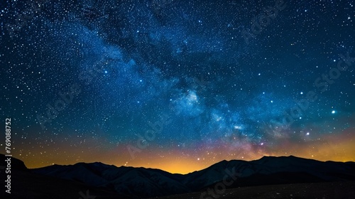 A mesmerizing Milky Way arcs across the night sky  illuminating a silent mountain valley with its celestial splendor..