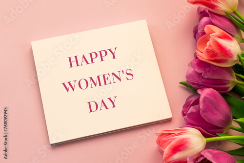 Happy Women's Day inscription, greeting card with tulips on a pink background