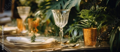 The dining table is elegantly arranged with a glass, several plates, and shiny silverware