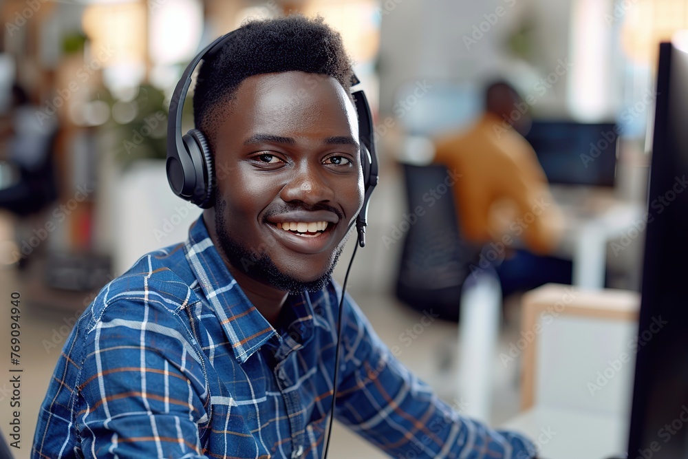 Obraz premium Young african american man receptionist with headset working in a call centre