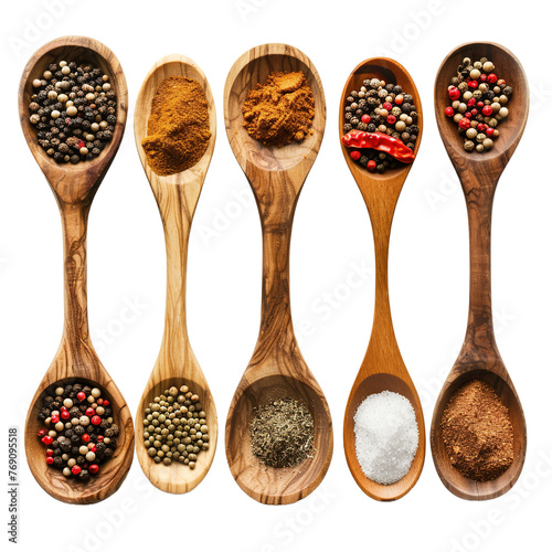Various spices in wooden spoons top view isolated on white or transparent background