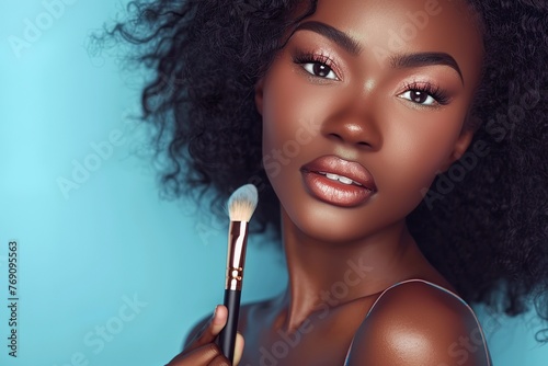 Portrait of african american woman with clean healthy skin holding cosmetic brush